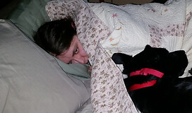 My daughter buried in blankets with a migraine and our therapy dog laying with her. Photo by author.